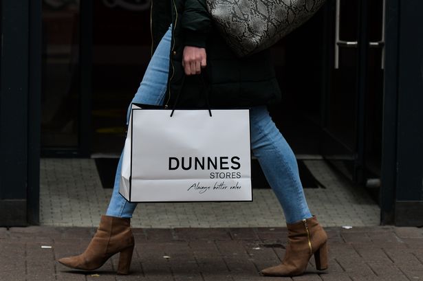A woman walks with Dunnes Stores shopping bag on Grafton Street in Dublin city centre